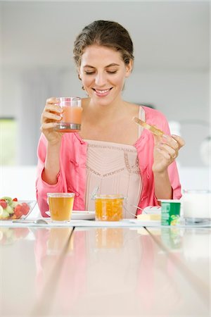 simsearch:6108-05864945,k - Woman having breakfast at a table Stock Photo - Premium Royalty-Free, Code: 6108-05864999