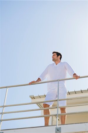 simsearch:6108-05859747,k - Man standing on the beach house Stock Photo - Premium Royalty-Free, Code: 6108-05865028