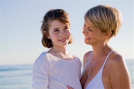 Woman with her daughter enjoying vacations on the beach Stock Photo - Premium Royalty-Free, Code: 6108-05865201