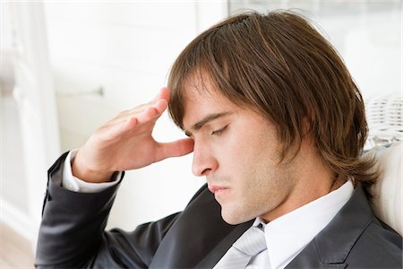 simsearch:6108-05863386,k - Close-up of a man suffering from a headache Stock Photo - Premium Royalty-Free, Code: 6108-05865520
