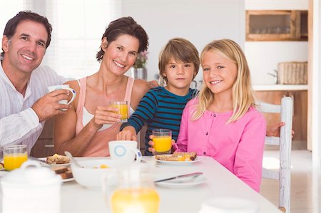 simsearch:6108-05856772,k - Portrait of a family having breakfast Stock Photo - Premium Royalty-Free, Code: 6108-05865836