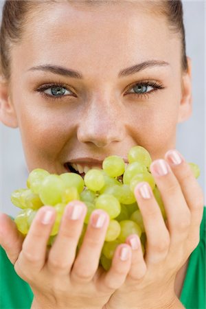 Woman eating grapes Stock Photo - Premium Royalty-Free, Code: 6108-05866128