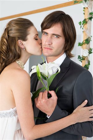 Bride kissing groom Stock Photo - Premium Royalty-Free, Code: 6108-05866293
