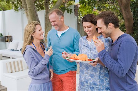 simsearch:6108-05861651,k - Four friends eating fruits and having fun Stock Photo - Premium Royalty-Free, Code: 6108-05866338