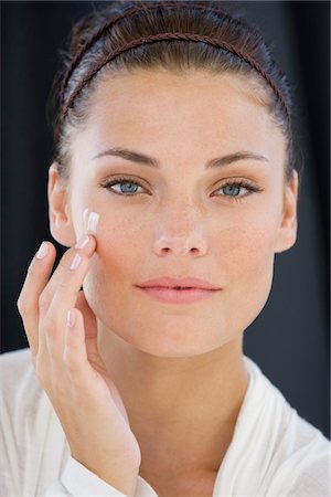 simsearch:6108-05873814,k - Woman applying cream on her face Stock Photo - Premium Royalty-Free, Code: 6108-05866471