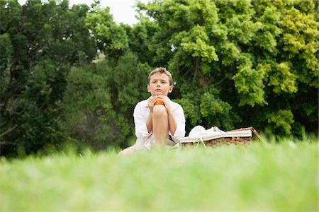 simsearch:6108-05863386,k - Boy sitting in a park Stock Photo - Premium Royalty-Free, Code: 6108-05866412