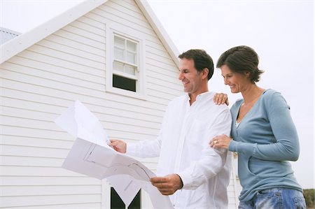 property - Couple looking at a blueprint of a house Stock Photo - Premium Royalty-Free, Code: 6108-05866691