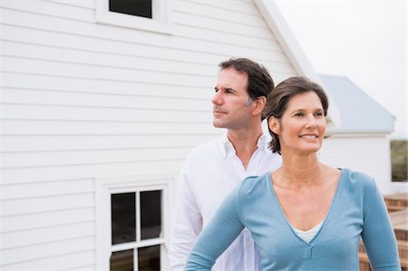 Couple standing together in front of a house Stock Photo - Premium Royalty-Free, Code: 6108-05866766