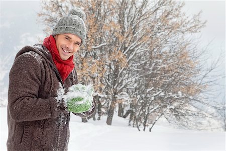 snow ball - Young man making a snowball Stock Photo - Premium Royalty-Free, Code: 6108-05866826