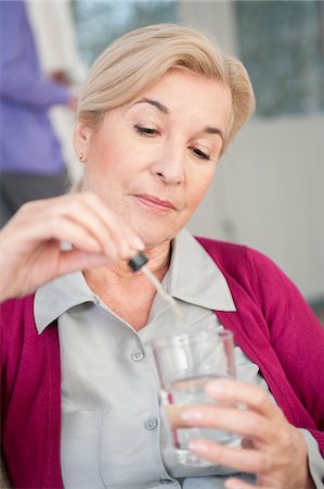 simsearch:6108-05867295,k - Close-up of a woman taking medicine Stock Photo - Premium Royalty-Free, Code: 6108-05867267