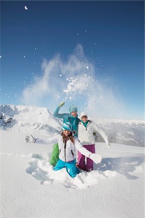 family winter - Couple and daughter in ski wear, throwing snow in air Stock Photo - Premium Royalty-Free, Code: 6108-05867204