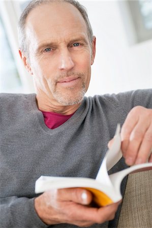 Portrait of a man holding a book Stock Photo - Premium Royalty-Free, Code: 6108-05867484