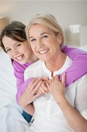 Portrait of a girl hugging her grandmother Stock Photo - Premium Royalty-Free, Code: 6108-05867549