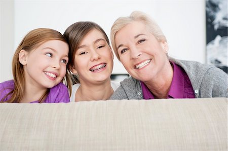 Portrait of a woman smiling with her granddaughters Stock Photo - Premium Royalty-Free, Code: 6108-05867557