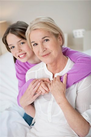 Portrait of a girl hugging her grandmother Stock Photo - Premium Royalty-Free, Code: 6108-05867562