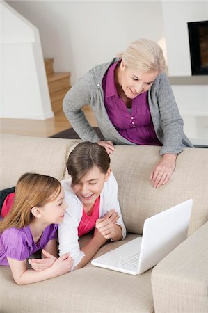 simsearch:400-05697169,k - Two girls using a laptop on a couch with their grandmother Stock Photo - Premium Royalty-Free, Code: 6108-05867591