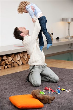 parent kneeling - Man playing with his son Stock Photo - Premium Royalty-Free, Code: 6108-05867510