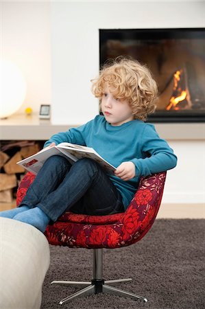 sitting socked - Boy reading a book Stock Photo - Premium Royalty-Free, Code: 6108-05867666