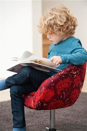 sitting socked - Boy reading a book Stock Photo - Premium Royalty-Free, Code: 6108-05867706