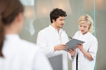 formal wear back view images - Doctors discussing a medical report Stock Photo - Premium Royalty-Free, Code: 6108-05867917