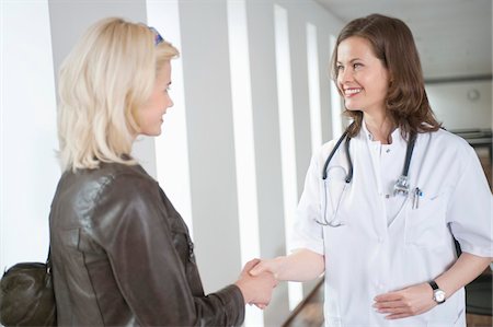 shake - Female doctor shaking hand with a woman Stock Photo - Premium Royalty-Free, Code: 6108-05868095