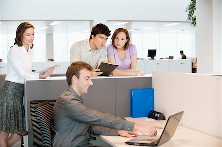 person in office cubicle - Business executives working in an office Stock Photo - Premium Royalty-Free, Code: 6108-05868821