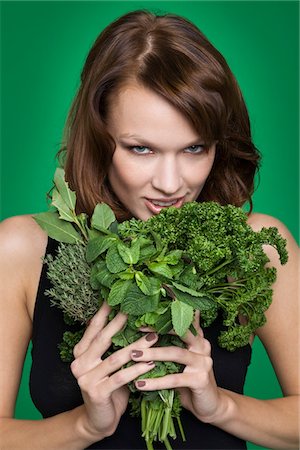 simsearch:6108-05869331,k - Young woman holding fresh herbs Stock Photo - Premium Royalty-Free, Code: 6108-05869130