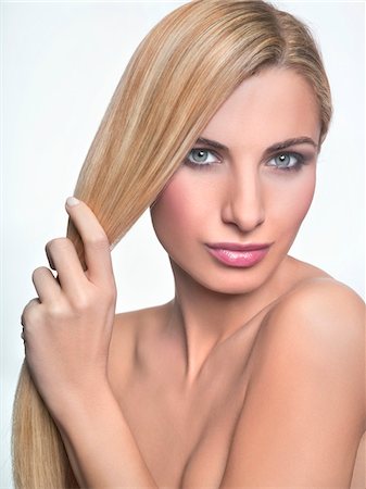 female nud - Young woman holding her hair Stock Photo - Premium Royalty-Free, Code: 6108-05869271