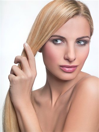 simsearch:6108-05869249,k - Young woman holding her hair Stock Photo - Premium Royalty-Free, Code: 6108-05869283