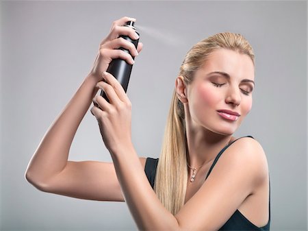 simsearch:6108-05869249,k - Young woman using hairspray Stock Photo - Premium Royalty-Free, Code: 6108-05869228