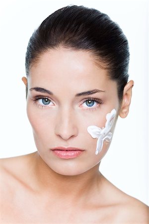 simsearch:6108-05869249,k - Young woman with moisturizer on her cheek Stock Photo - Premium Royalty-Free, Code: 6108-05869389