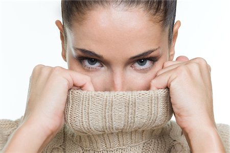 embarrassed women - Young woman covering her face with sweater Stock Photo - Premium Royalty-Free, Code: 6108-05869394