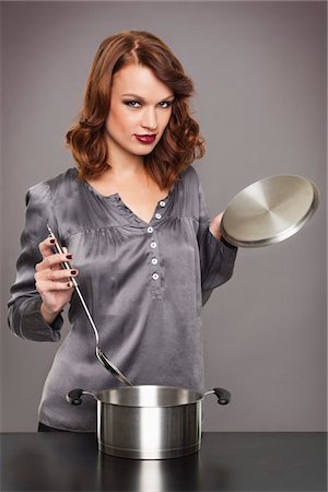 simsearch:6108-05869331,k - Young woman cooking Stock Photo - Premium Royalty-Free, Code: 6108-05869320