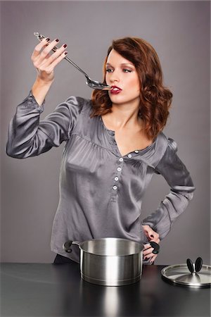 simsearch:6108-05869331,k - Young woman tasting food Stock Photo - Premium Royalty-Free, Code: 6108-05869333