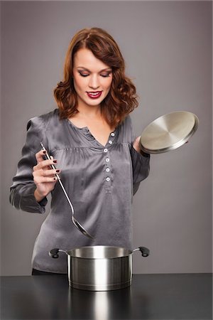 simsearch:6108-05869331,k - Young woman cooking Stock Photo - Premium Royalty-Free, Code: 6108-05869339