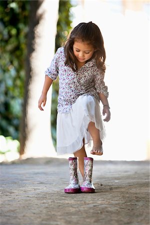 Cute girl wearing shoes Stock Photo - Premium Royalty-Free, Code: 6108-05869474