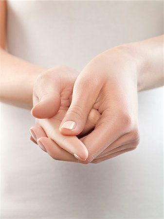 shiatsu - Woman pinching finger, close-up Stock Photo - Premium Royalty-Free, Code: 6108-05869427