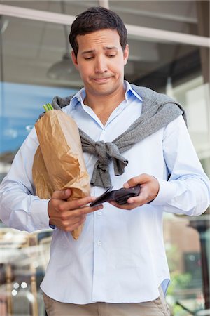 poverty - Mid adult man checking the empty wallet with paper bag full of vegetables Stock Photo - Premium Royalty-Free, Code: 6108-05869579