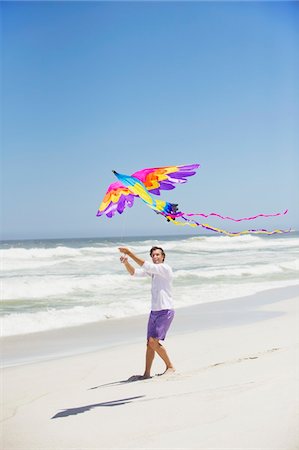 sky in kite alone pic - Mid adult man flying kite Stock Photo - Premium Royalty-Free, Code: 6108-05869994