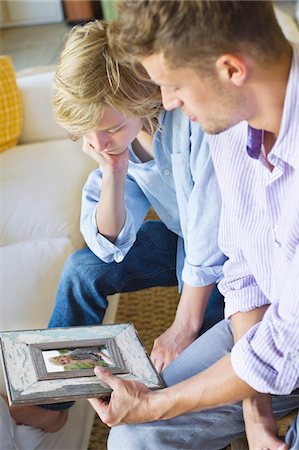 sad african children - Man and a little boy looking at picture frame Stock Photo - Premium Royalty-Free, Code: 6108-05870371