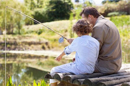 Father and son fishing in a lake Stock Photo - Premium Royalty-Free, Code: 6108-05870621