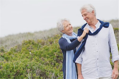 senior couple on beach - Senior woman putting sweater on husband's shoulder on the beach Stock Photo - Premium Royalty-Free, Code: 6108-05870967