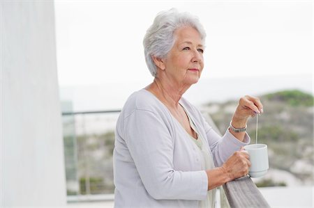 senior coffee alone - Senior woman holding a coffee cup Stock Photo - Premium Royalty-Free, Code: 6108-05871005