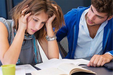 friend console - University student consoling his friend in a classroom Stock Photo - Premium Royalty-Free, Code: 6108-05871257