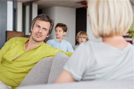 simsearch:6108-05872043,k - Couple having conversation while children standing in background Stock Photo - Premium Royalty-Free, Code: 6108-05871211