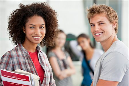 Portrait of two university students smiling Stock Photo - Premium Royalty-Free, Code: 6108-05871304