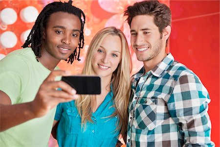 simsearch:6108-06907036,k - Friends taking a picture of themselves with a mobile phone Stock Photo - Premium Royalty-Free, Code: 6108-05871476