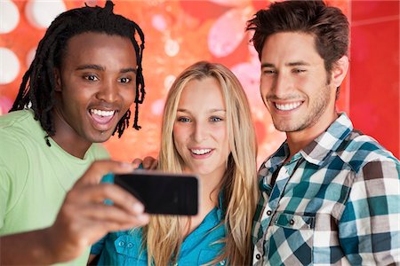 simsearch:6108-06907036,k - Friends taking a picture of themselves with a mobile phone Stock Photo - Premium Royalty-Free, Code: 6108-05871479