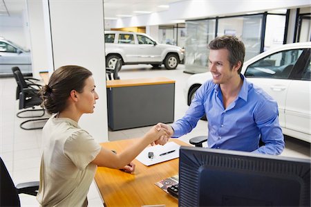 Saleswoman shaking hands with her customer Stock Photo - Premium Royalty-Free, Code: 6108-05871428