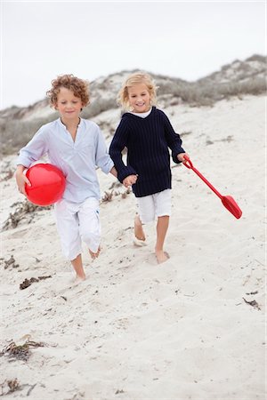 shovel (hand tool for digging) - Children running on sand at beach Stock Photo - Premium Royalty-Free, Code: 6108-05871583